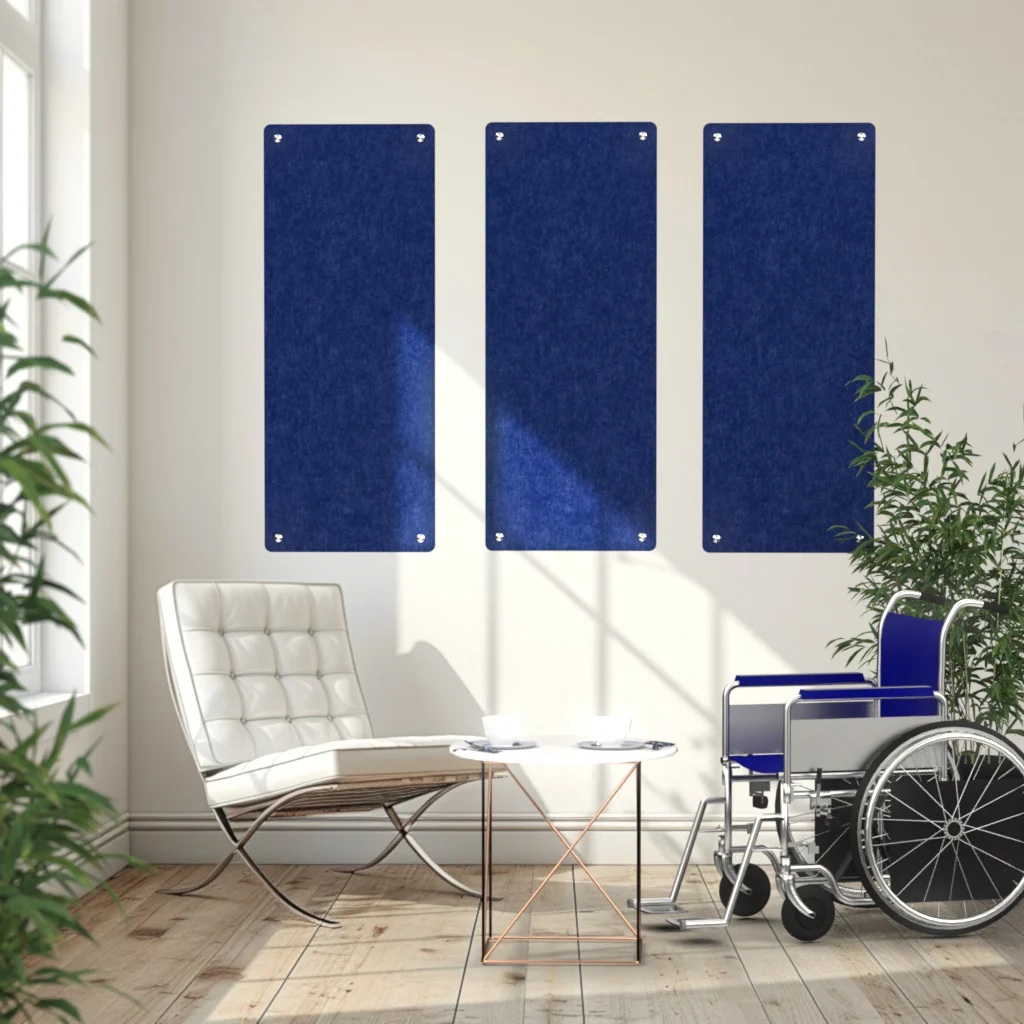 Three blue acoustic wall panels above a seating area with a wheelchair in a nursing home.