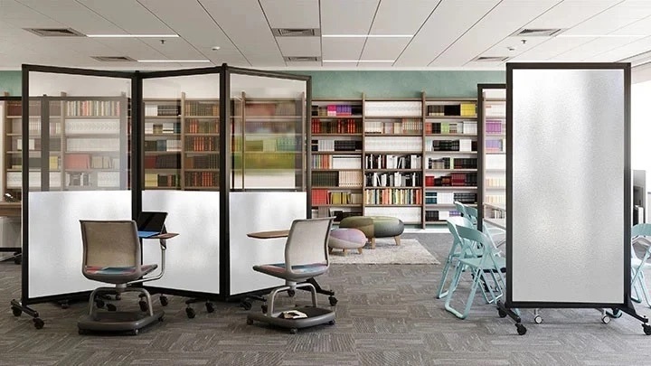 Frosted mobile room dividers creating semi-private seating areas in a library