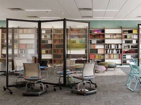 Clear mobile dividers separating study tables in a library.