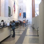 Room dividers in a museum create a hallway for guests to separate paying guests from the entryway