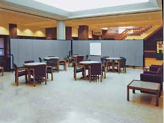 Rolling walls section off a portion of a library lobby to create a meeting area