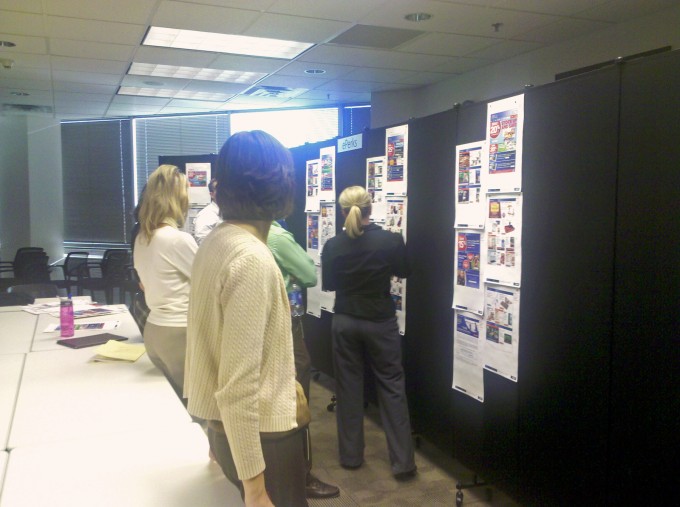 Black Room Divider used at meeting An office uses black room dividers to review a marketing plan
