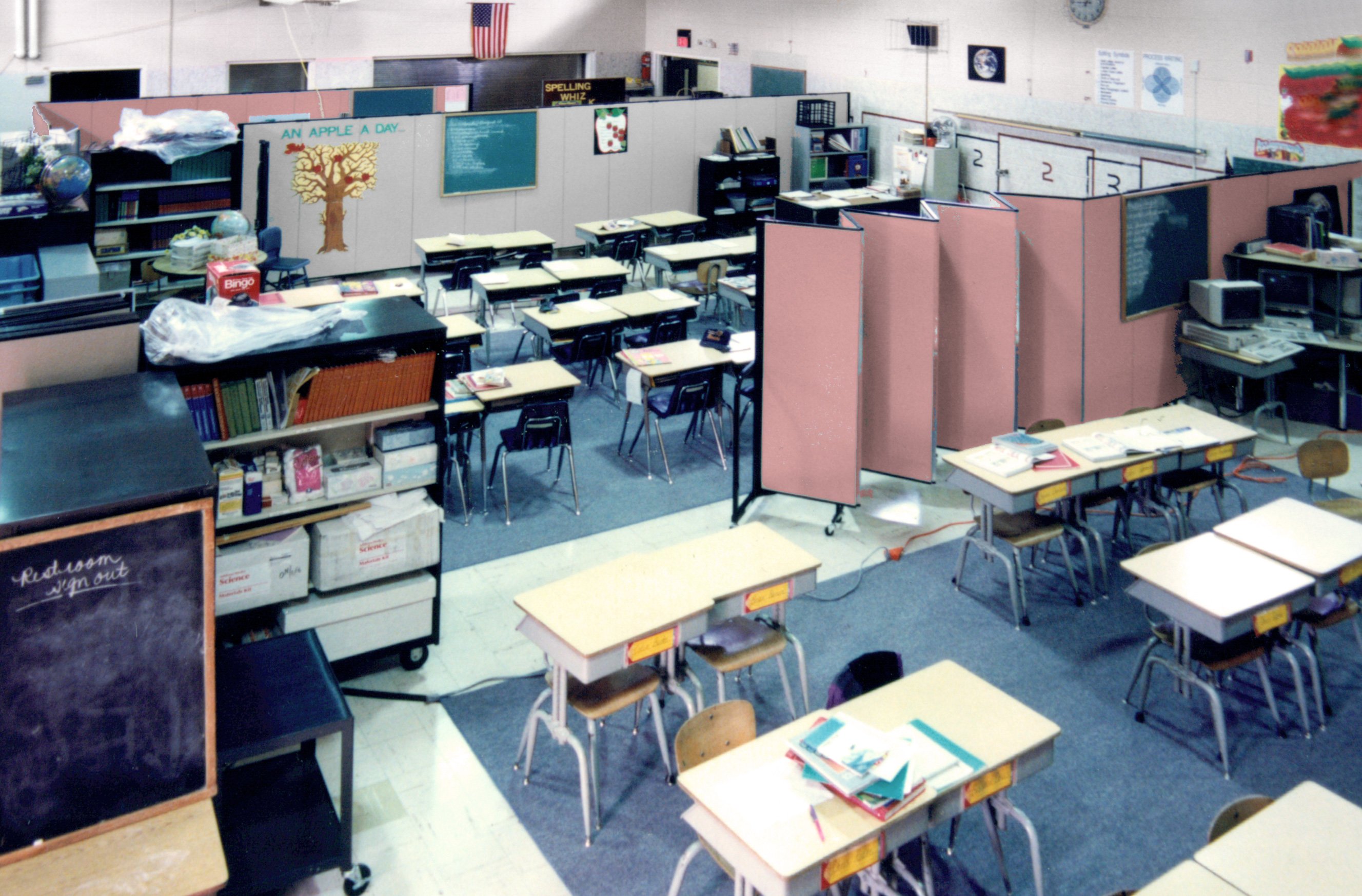 Two portable walls create three classrooms in a gym during school construction