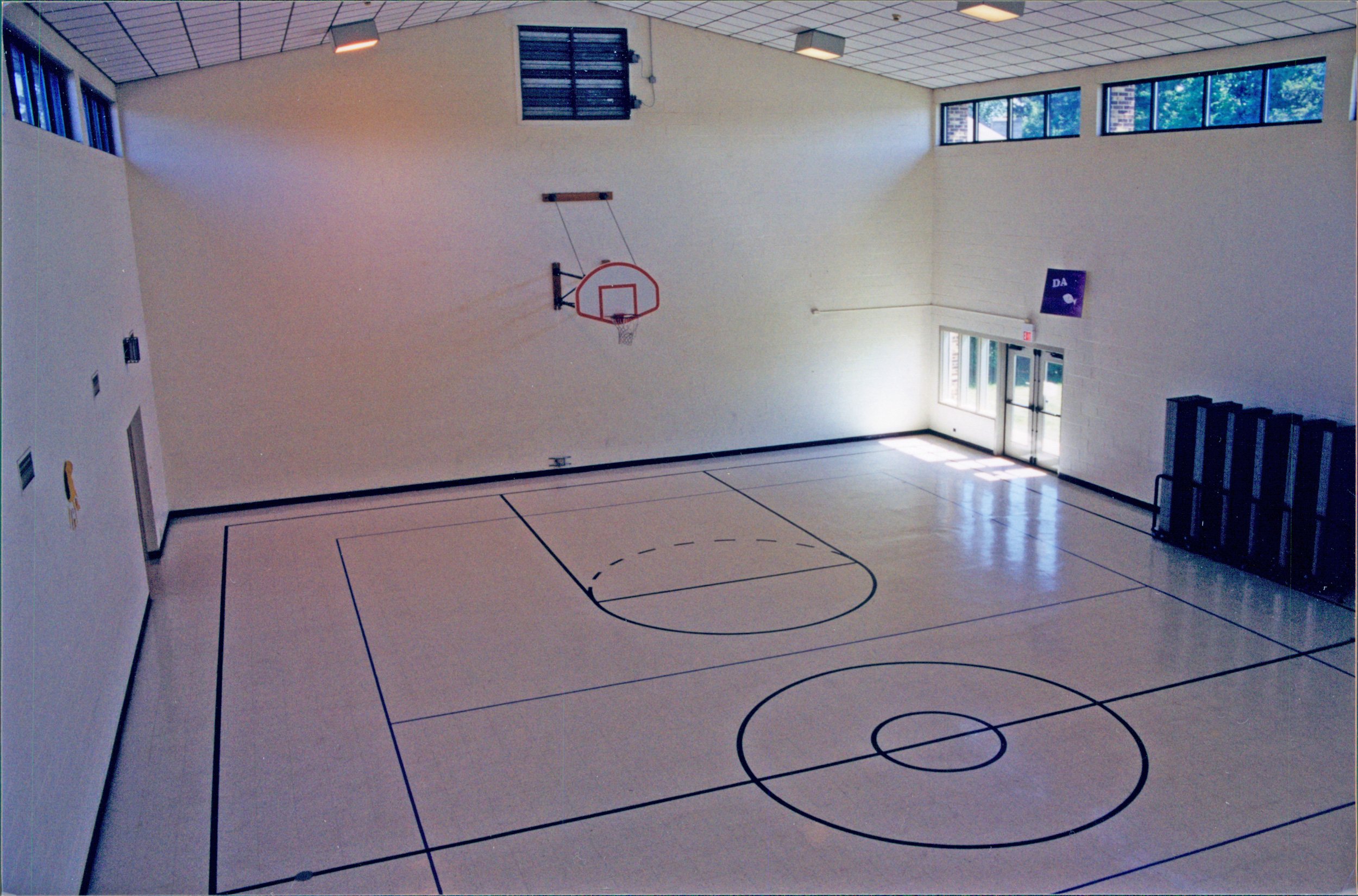 Open gym with six stored dividers on the side