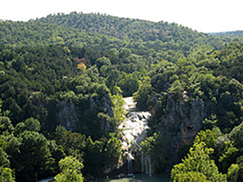 Looking down on a forest with a waterfall