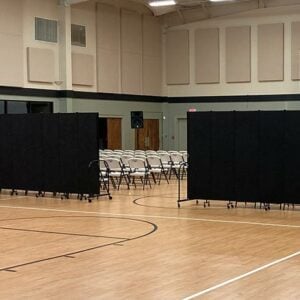 superior portable room dividers hiding chairs during a presentation