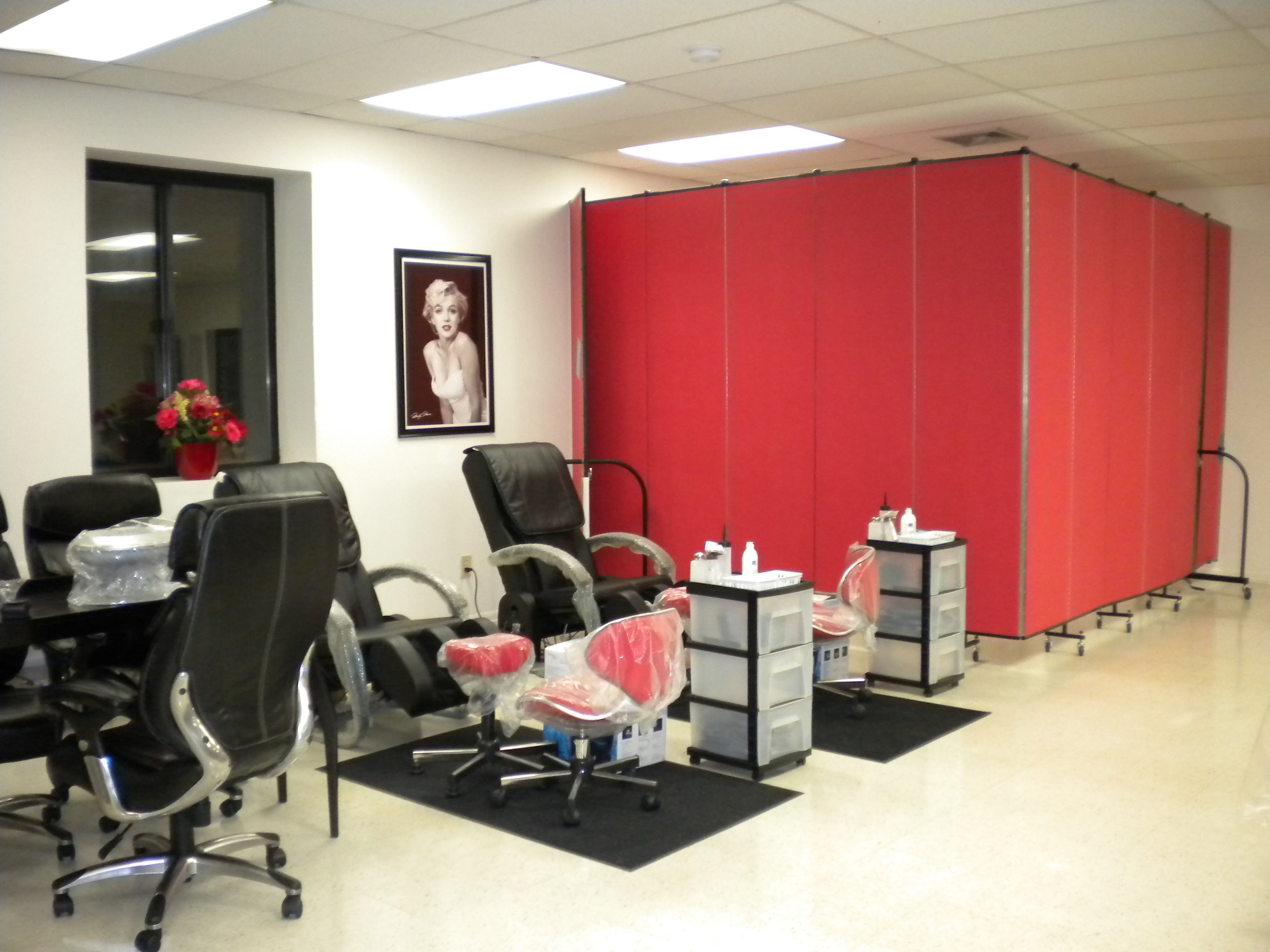 stylish red room divider is shaped into an L against two walls to form a square room