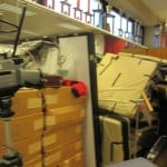 Screenflex Room Divider Walls shield stacks of unused items in an office.