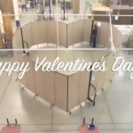 Happy Valentine's Day over Screenflex Room Dividers formed into a heart shape.