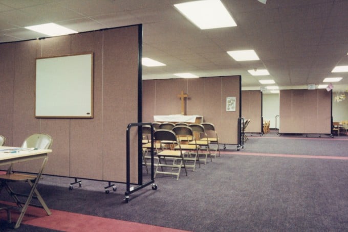 Room dividers are arranged to create Sunday School Classrooms in a church basement
