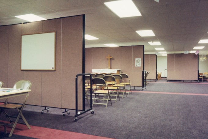 Room dividers are arranged to create Sunday School Classrooms in a church basement