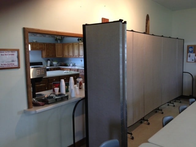 A Screenflex Room Divider provides privacy between the cafeteria and kitchen