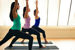 Three women in a yoga pose