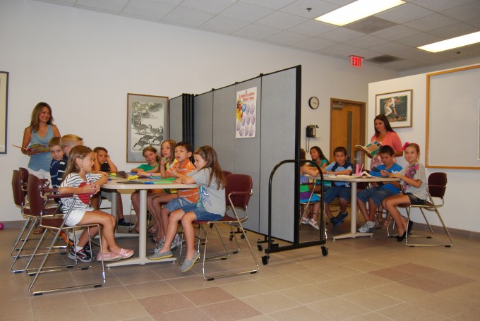 Two classrooms of young students obtain privacy with classroom partitions