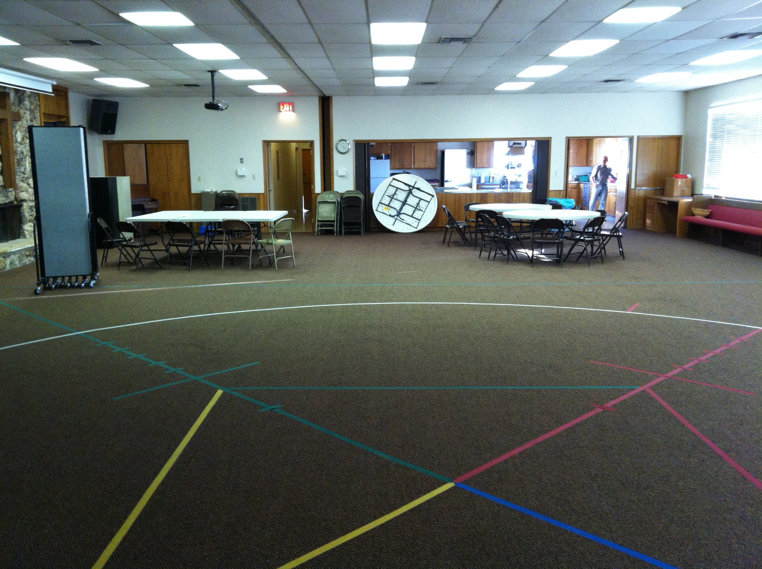 Awana circle taped to the carpet of a church multi purpose room