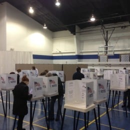 Rows of voting booths in a gym
