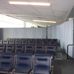 Private passenger waiting room in an airport created with Screenflex Portable Room Dividers.
