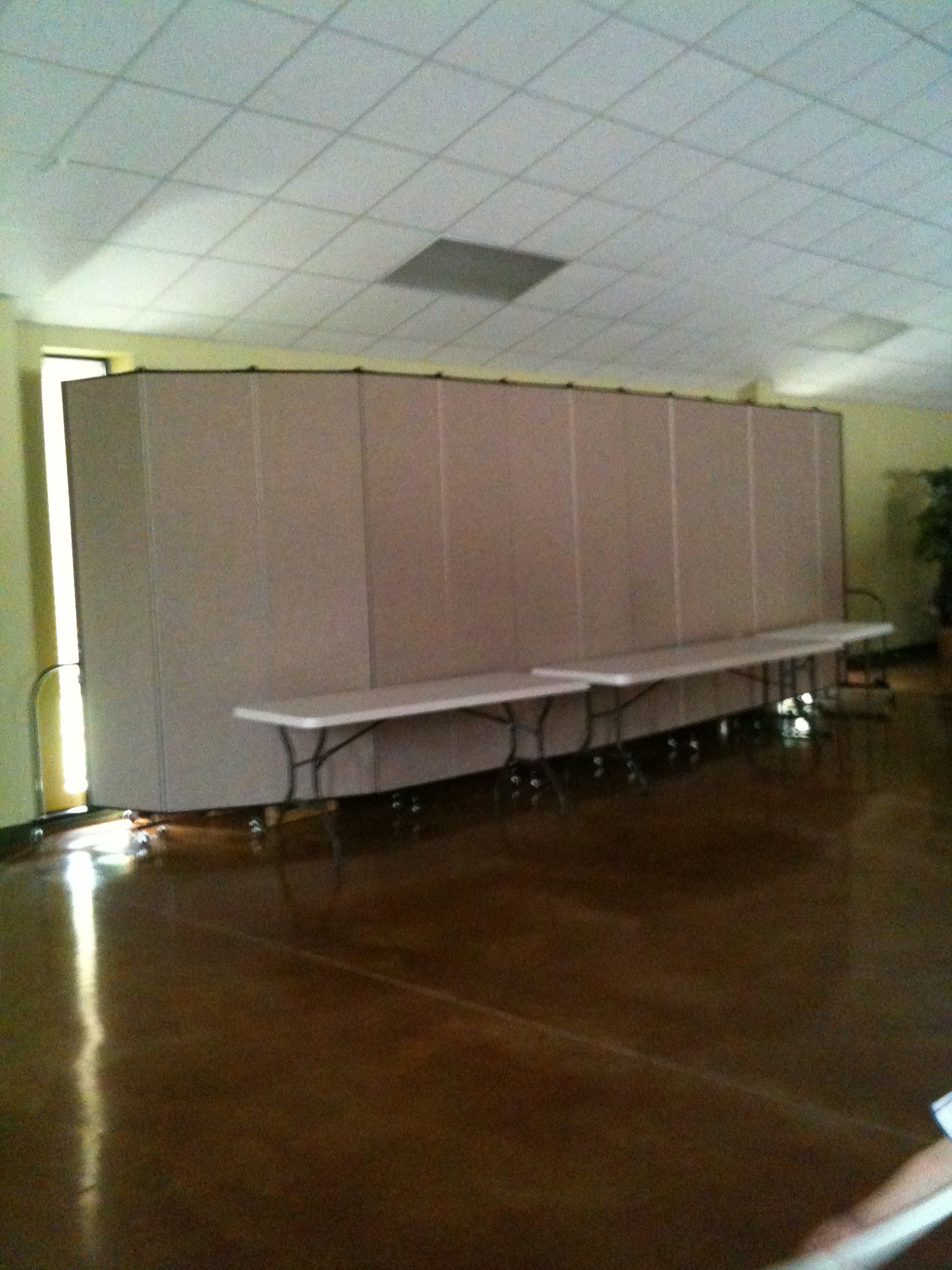 Divider wall protects unused items from view in a banquet hall.