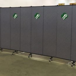 Grey room divider with Girl Scout logo on every-other panel