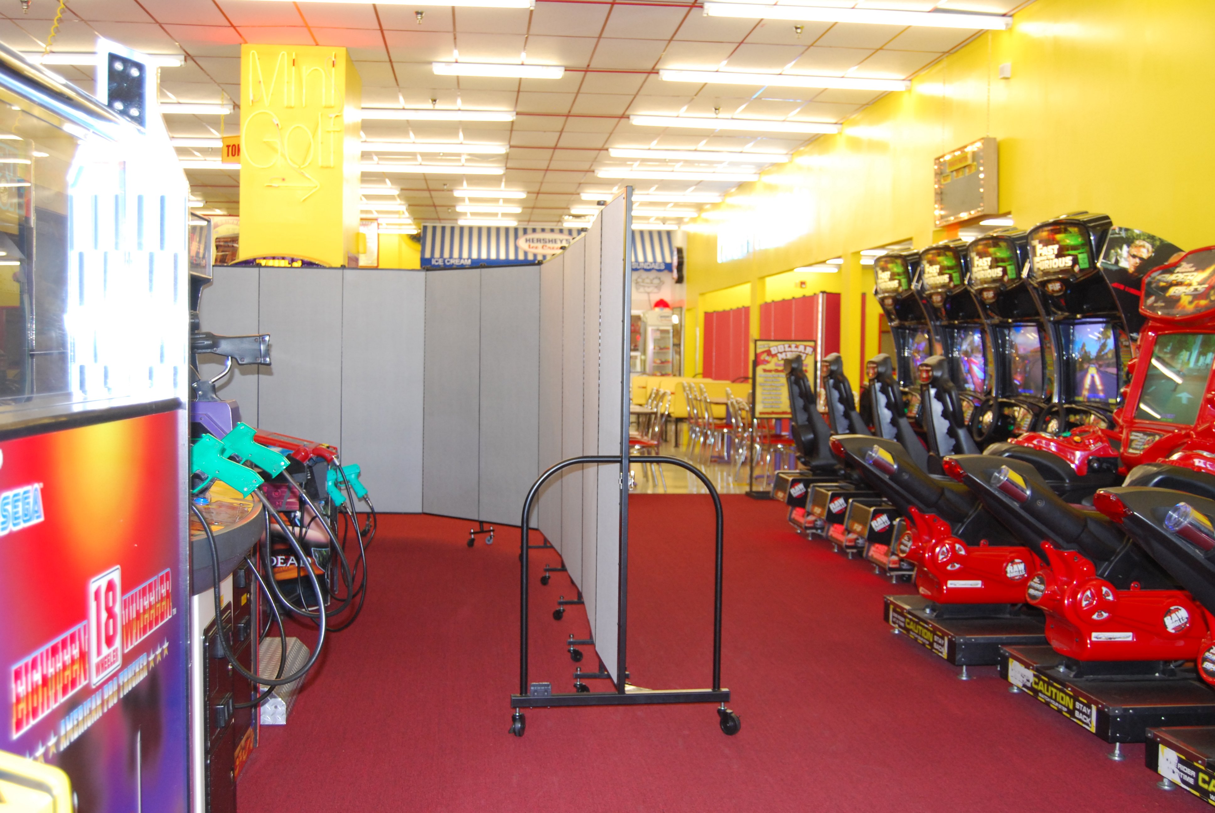 portable crowd control barrier at an indoor amusement park to separate games from dining area.