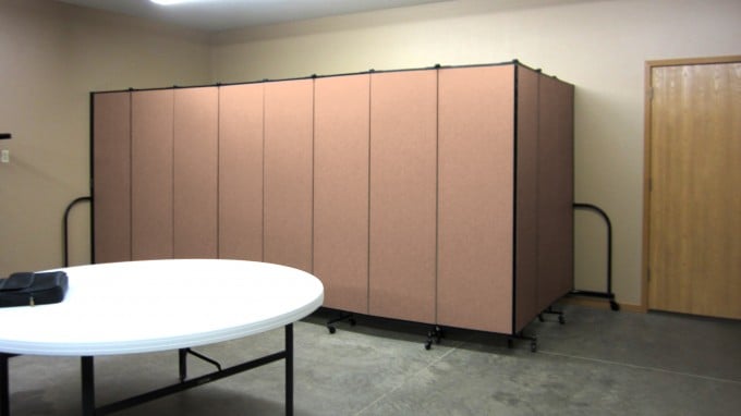 Folding partition walls hide tables and chairs