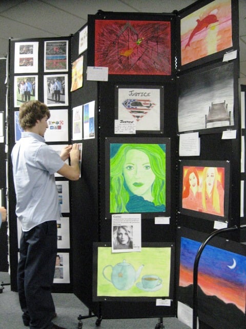 A Screenflex partition used to display student artwork for an exhibitiion