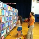 public viewing a school art exhibit