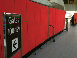 Red airport dividers secure a gate terminal