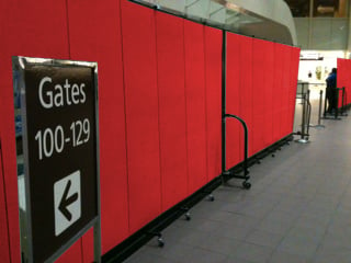 Red airport dividers secure a gate terminal