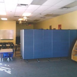 A nursing room is created with privacy screens in an empty room