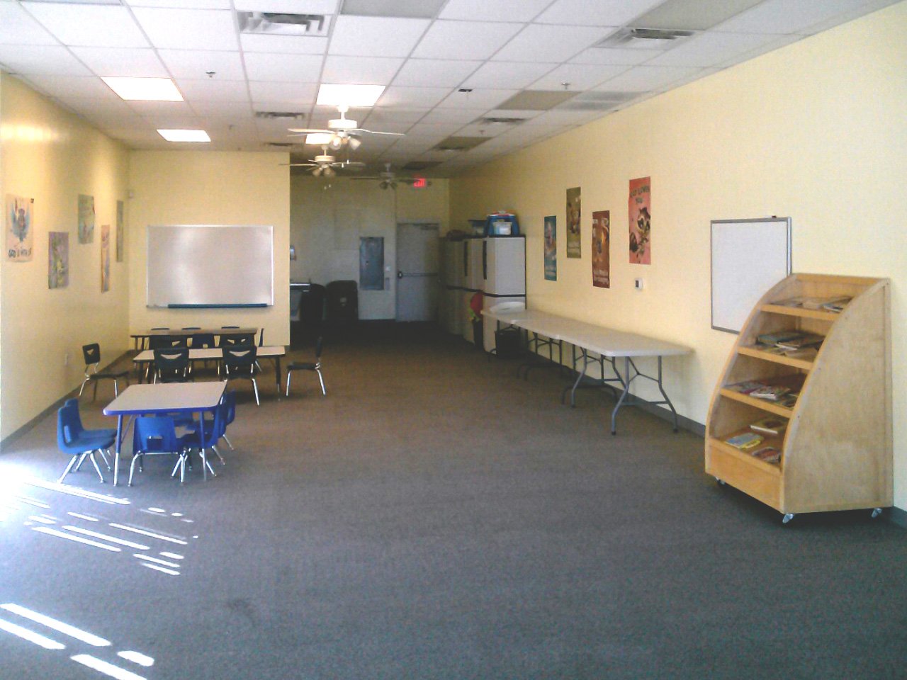 A large room serves as a kitchen and a childcare room in a church