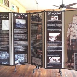 Historical museum display information hung on a 5 panel room divider