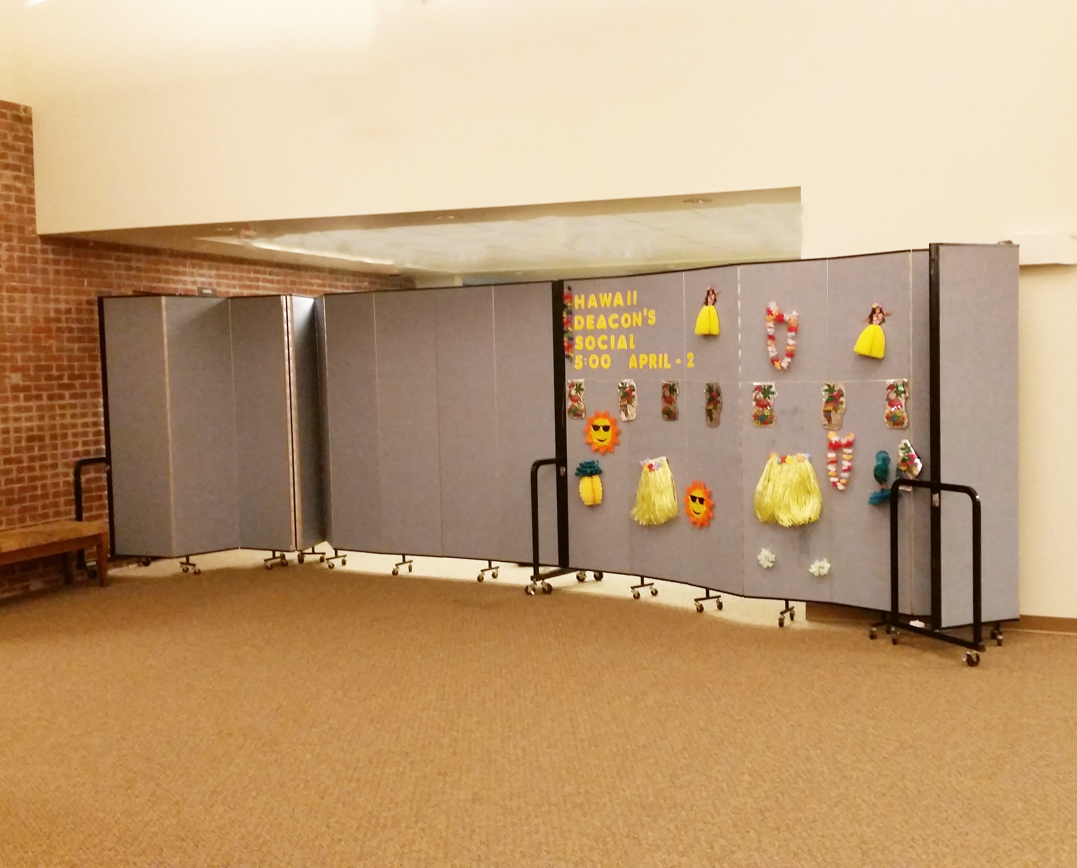 A portable partition is used to create more classrooms in a church hallway