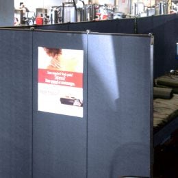 A set of massage tables are hidden from a workout area