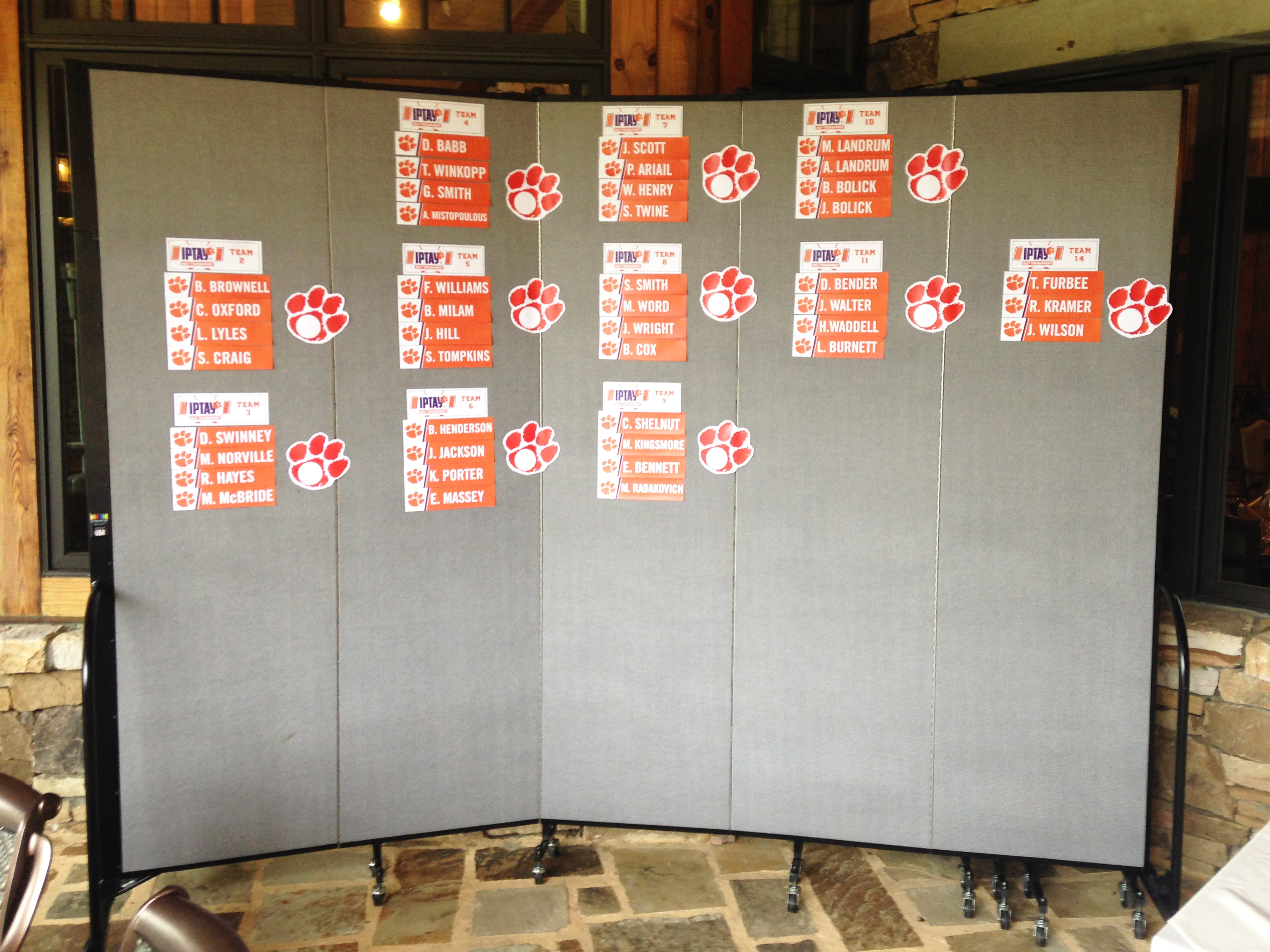 Moveable walls are used to display golf score cards for a tournament