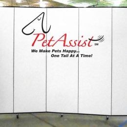 Pet Assist logo on a white portable room divider