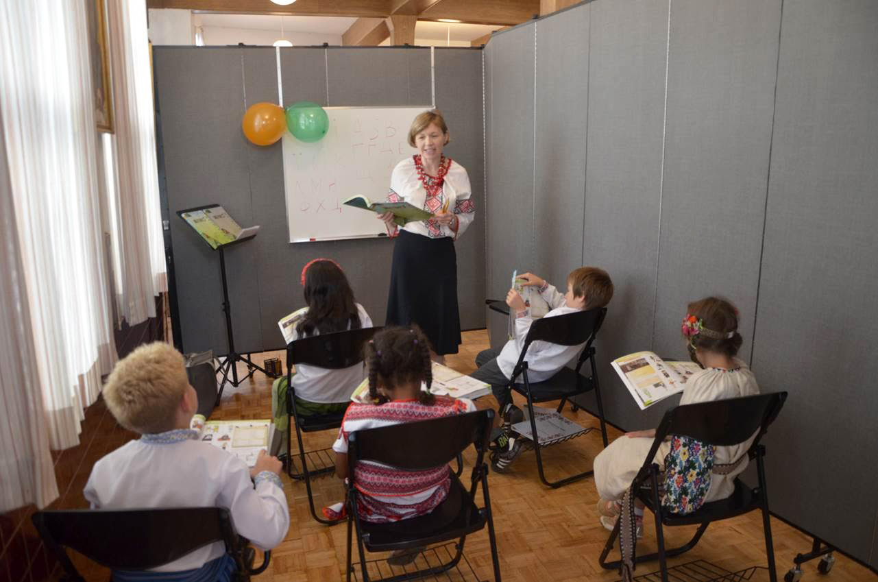 A teacher converses with her class