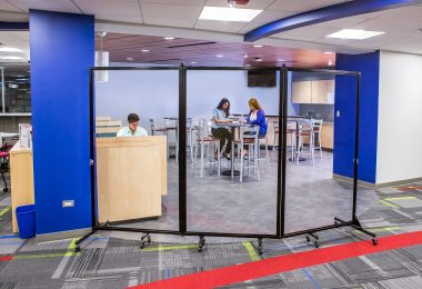 Children sitting in a small cafeteria behind a clear wall perfect when you need more space