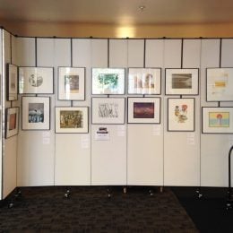 Artwork hangs on Screenflex art display panels