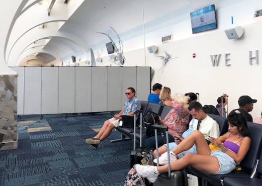 Passengers wait to board a cruise ship