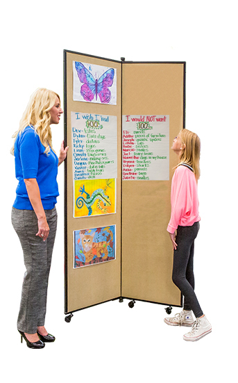 A teacher and a student looking at 100th day of school posters tacked onto a display tower