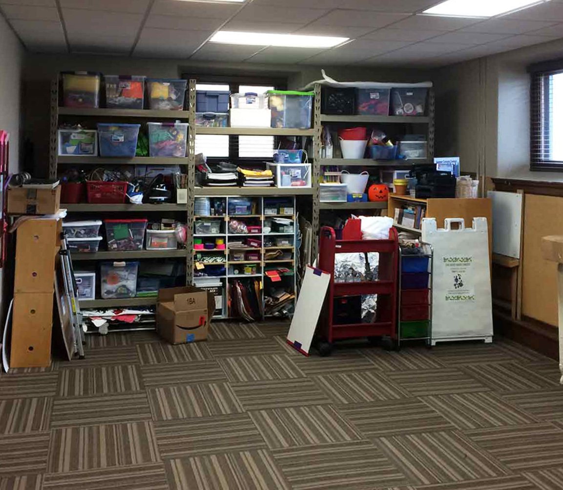 Items are stacked on shelves and piled on the floor