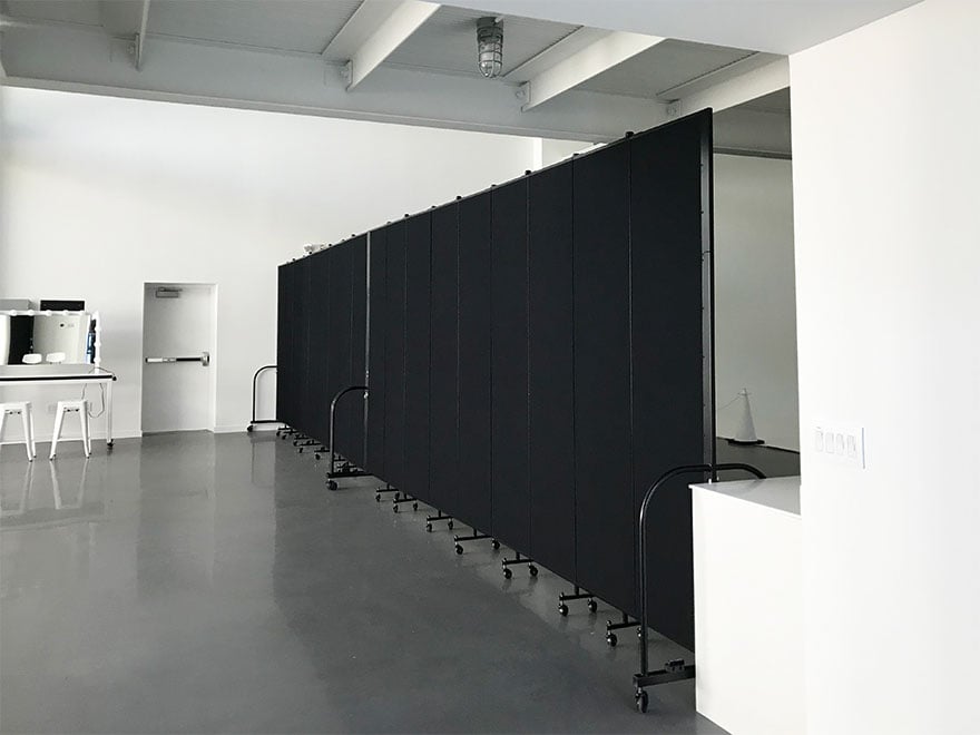 Black Screenflex room dividers create two area in a large white room