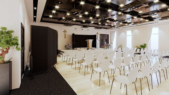 Black room dividers as a church backdrop and white chairs in rows