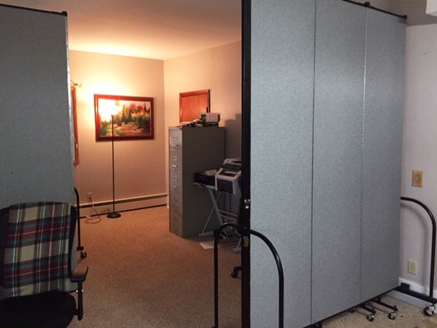 Two room dividers create a bedroom for a inhome care center