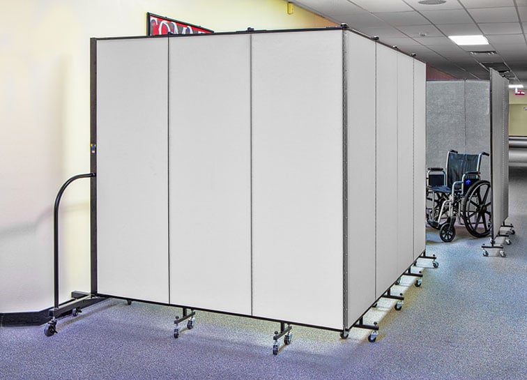 Two dividers set up in a hallway to provide medical space for patients