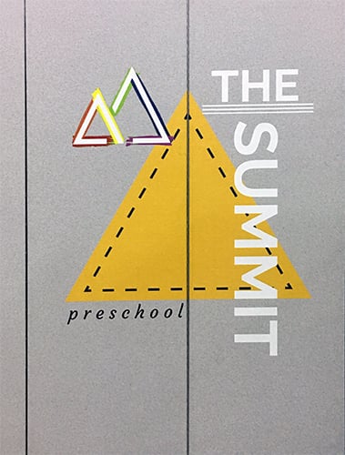 A close up of The Summit preschool logo printed on a divider