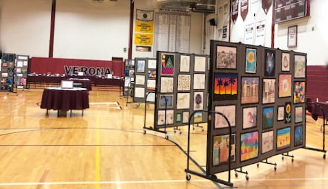 Art display panels lined up in a gym