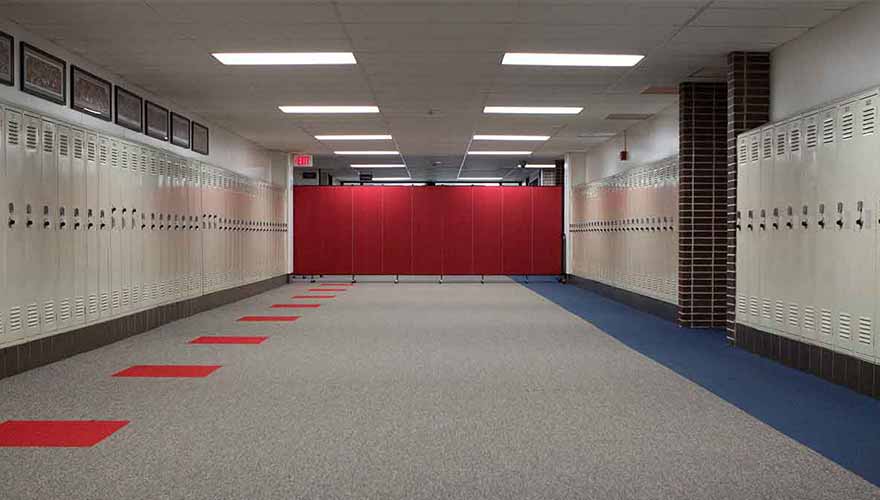 Red divider blocks entrance to a school hallway