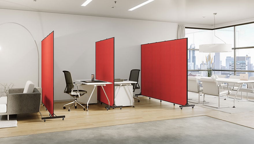 A trio of red room dividers separate workstations